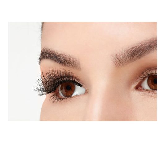A model wearing Ardell Double Wispies in a side view showing its curly & long length lashes