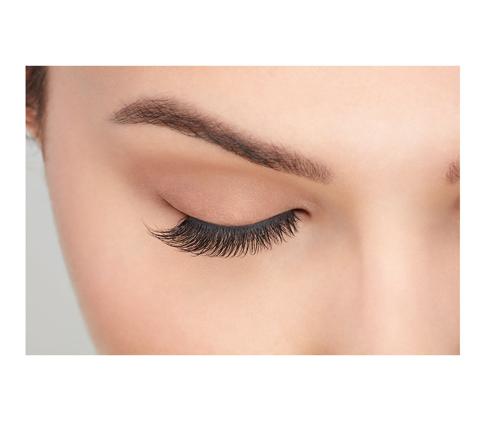 A model wearing Ardell's Faux mink 811 with close right eye showing its finely tapered end & the flared, winged out style